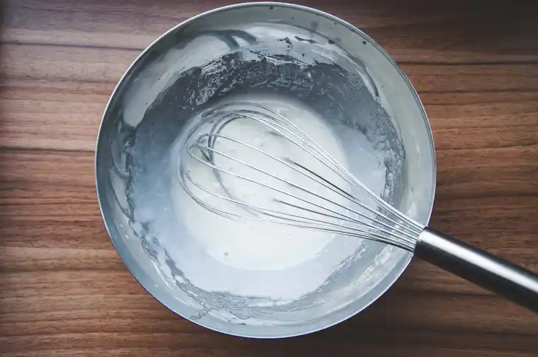 Food emulsion being mixed to disperse oil droplets in water
