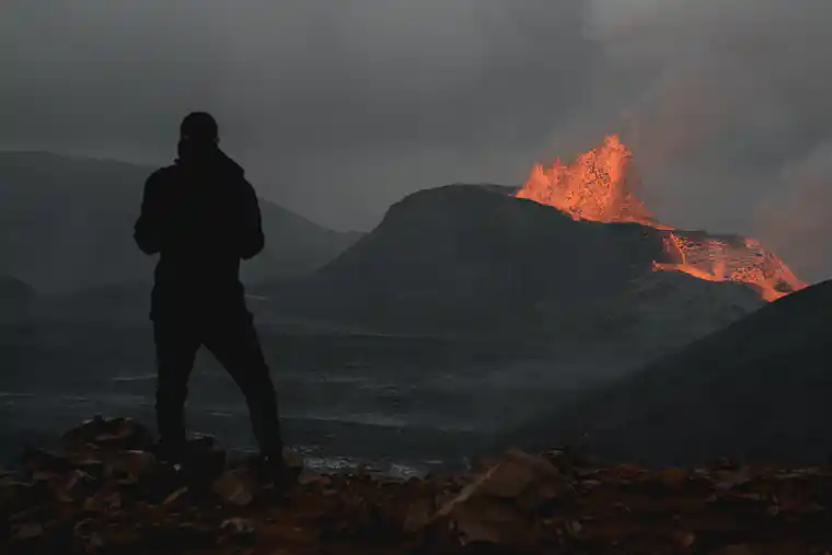Volcano monitoring observer watching volcanic activity from a safe distance